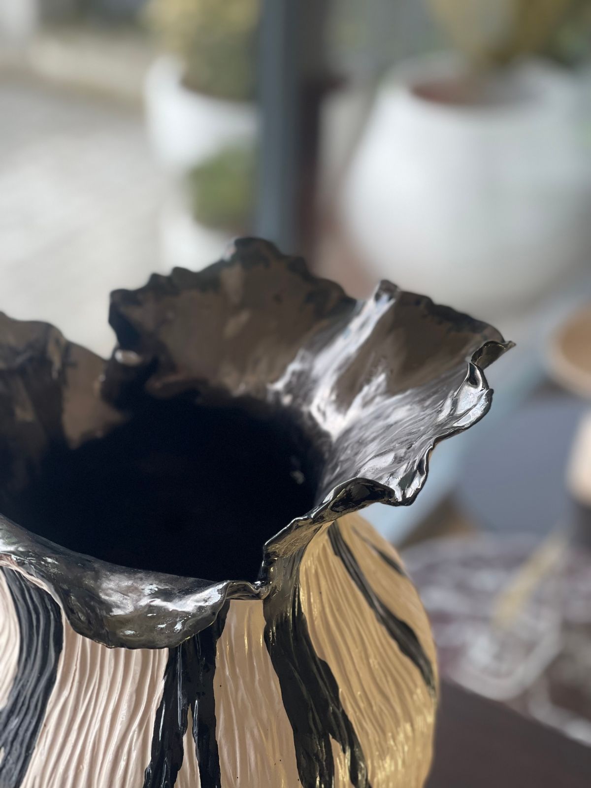 Bonie Iconic Vase — Black — A black and cream striped body with a glossy black, undulating rim.