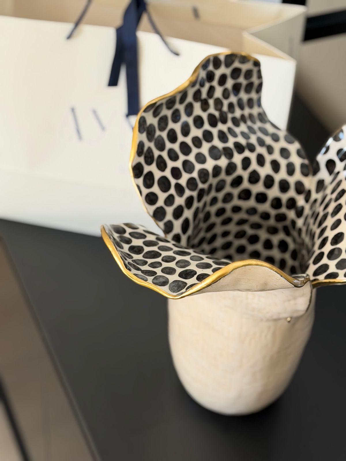 Bonie Iconic Vase — Dots — A cream body with a black-dotted, gold-edged petal rim.