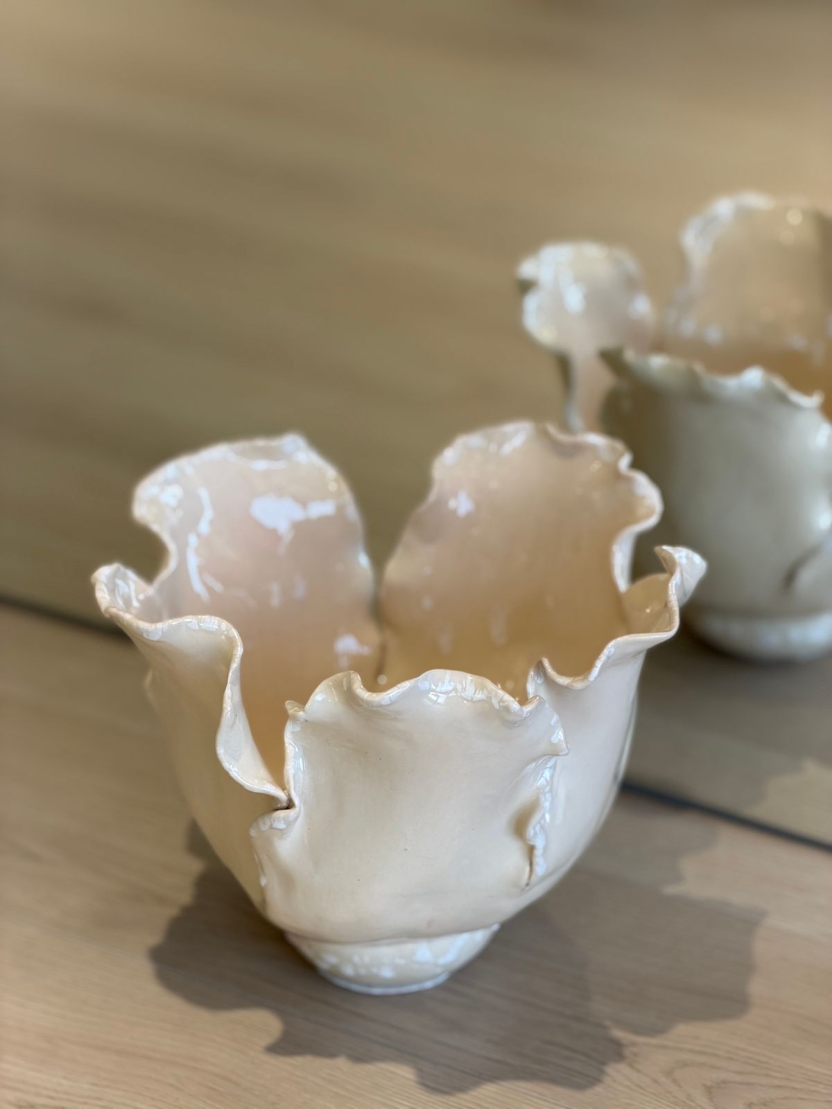 Bonie Lotus Vase — A low vase of layered petals in cream and peach tones.