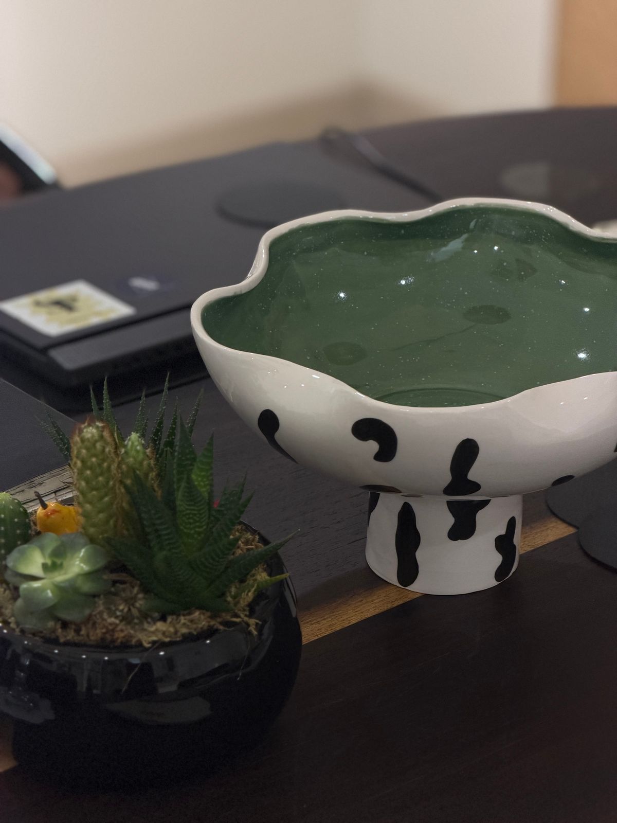 Dalmatian Pedestal Bowl — A white, black-spotted body with an undulating rim. The inside is glazed in six colours: olive green, butter yellow, lilac, deep terracotta, rose and baby blue.