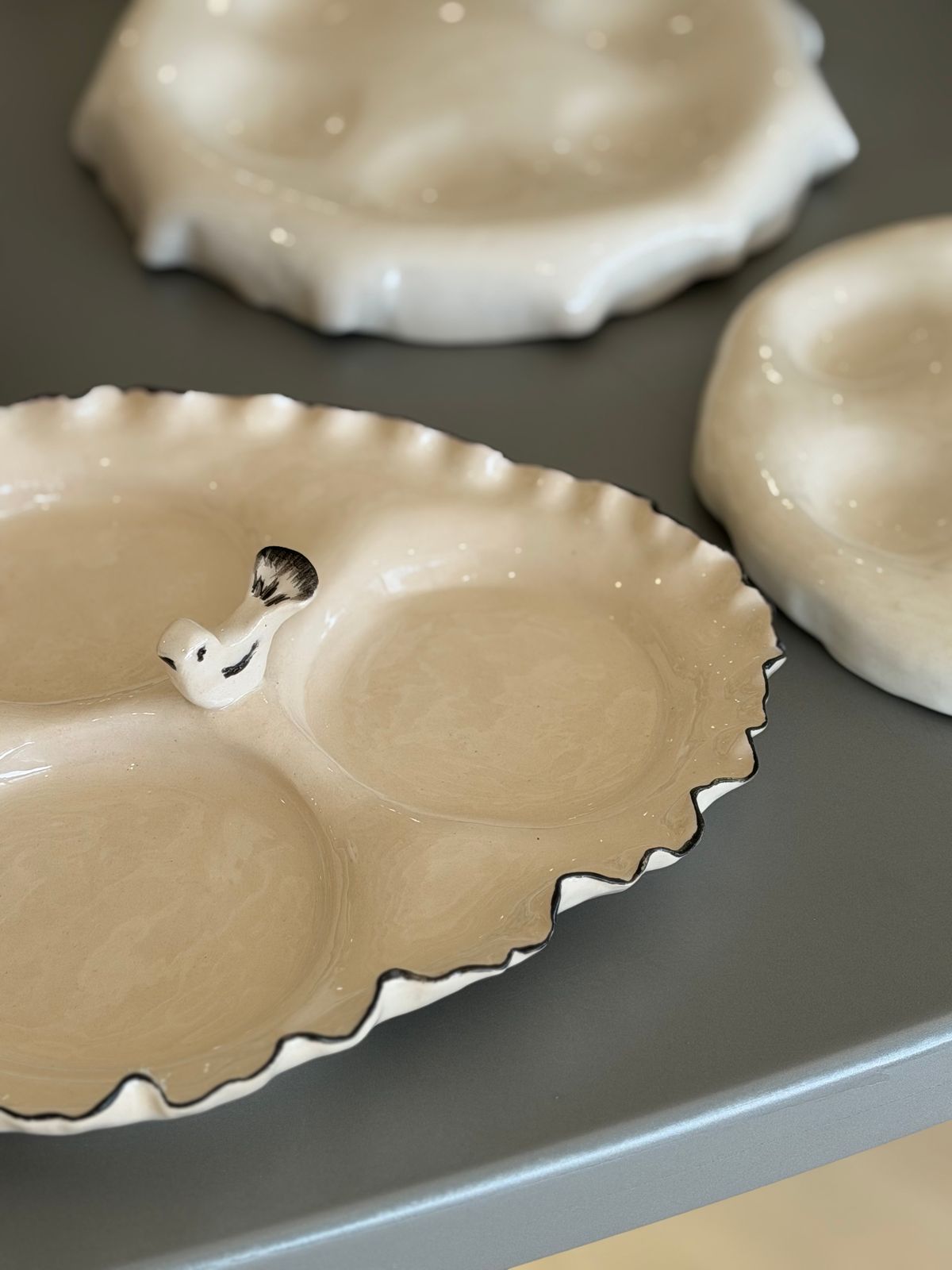 Bird Serving Dish — A divided serving dish with a black-lined edge and a small bird figure.