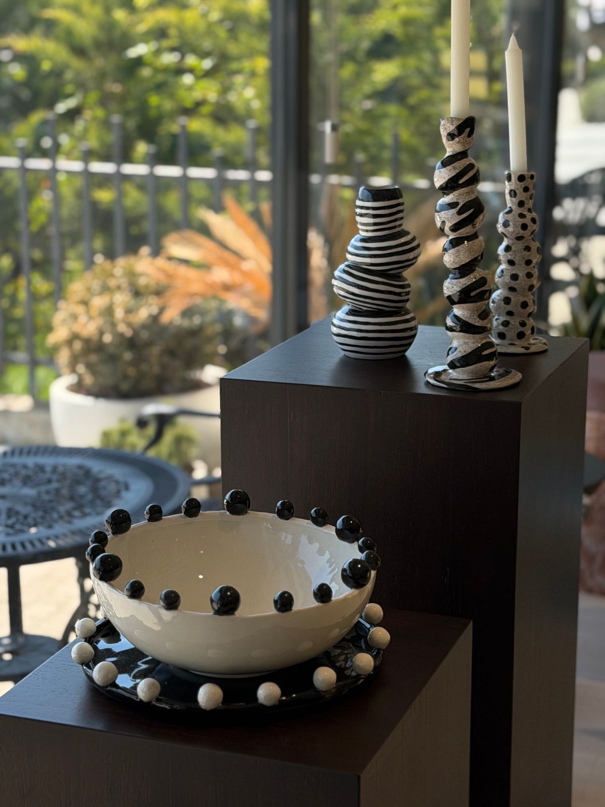 Dot Pedestal Bowl — A bowl and pedestal pieces ringed with black spheres.