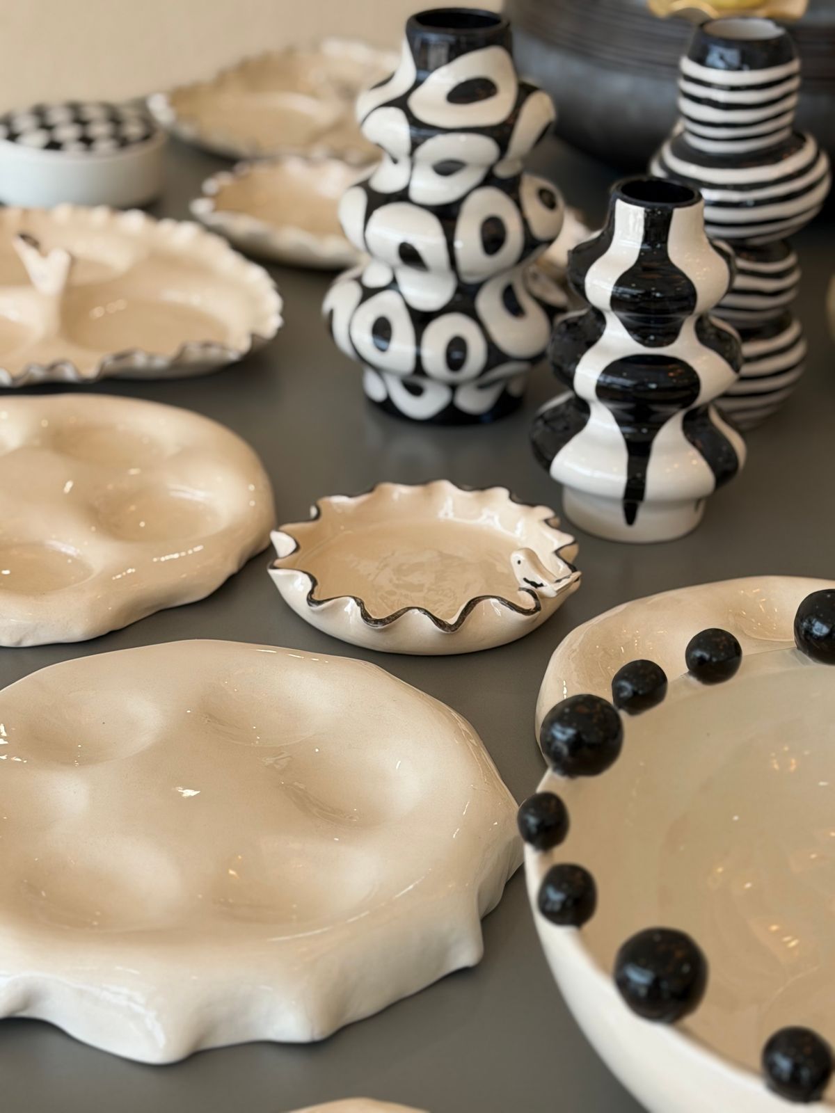 Sculptural Vase with Serving Dish — A sculptural black-and-white vase with an accompanying serving dish.
