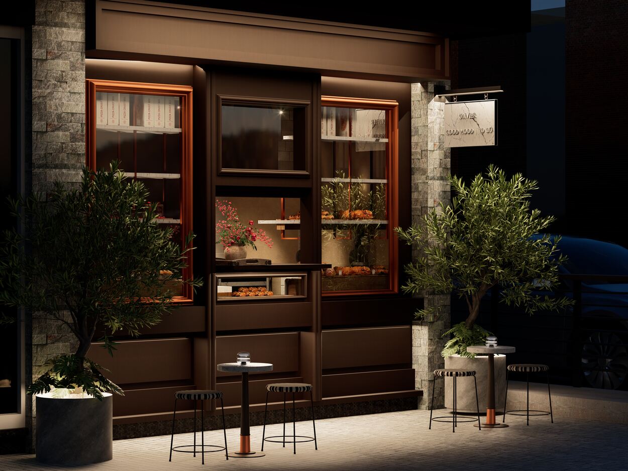 Evening facade and signage; the seating area framed by olive trees