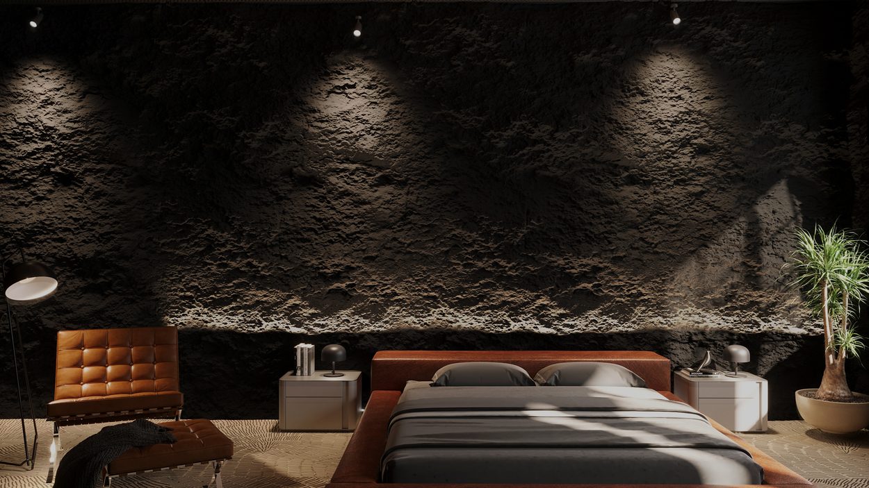 Bedroom — a dark textured wall grazed by spotlights, with leather furniture